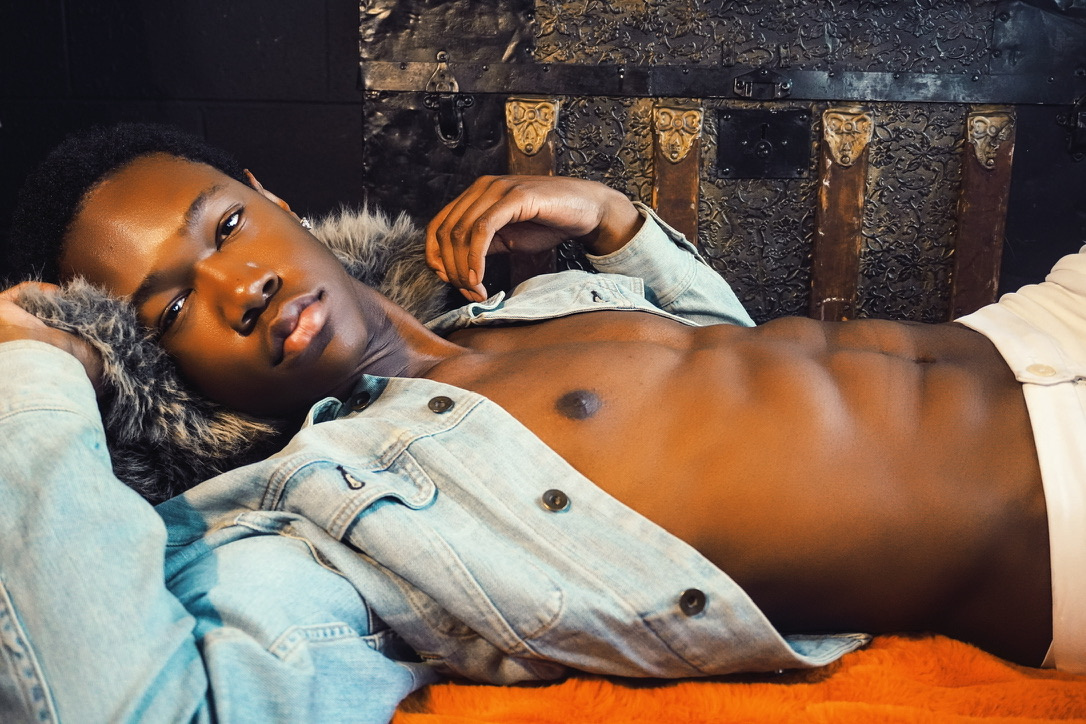 Reclining portrait in a pale denim jacket