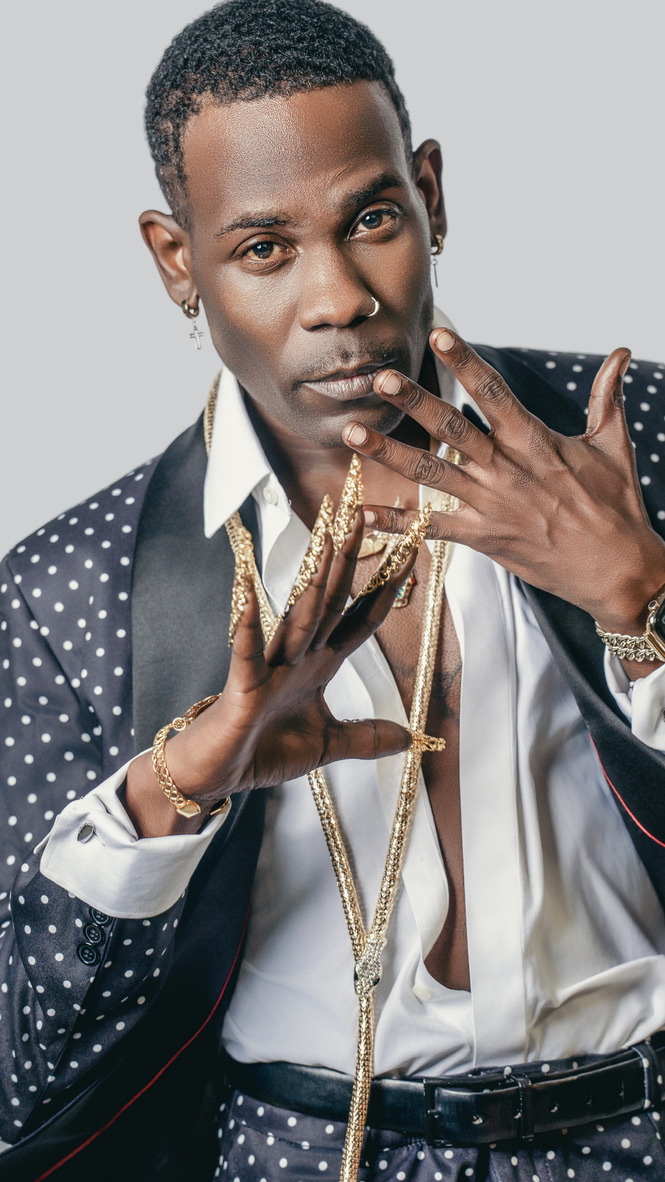 Studio portrait in a dotted suit with gold jewelry and expressive hands